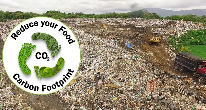 Reduce your food carbon footprint logo over a landfill image of trash and food waste with trucks organizing the area.