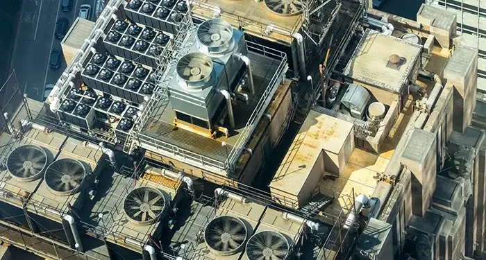 Arial view of a building with multiple rooftop HVAC units and air conditioners