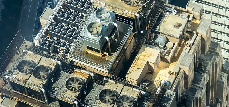 Arial view of a building with multiple rooftop HVAC units and air conditioners